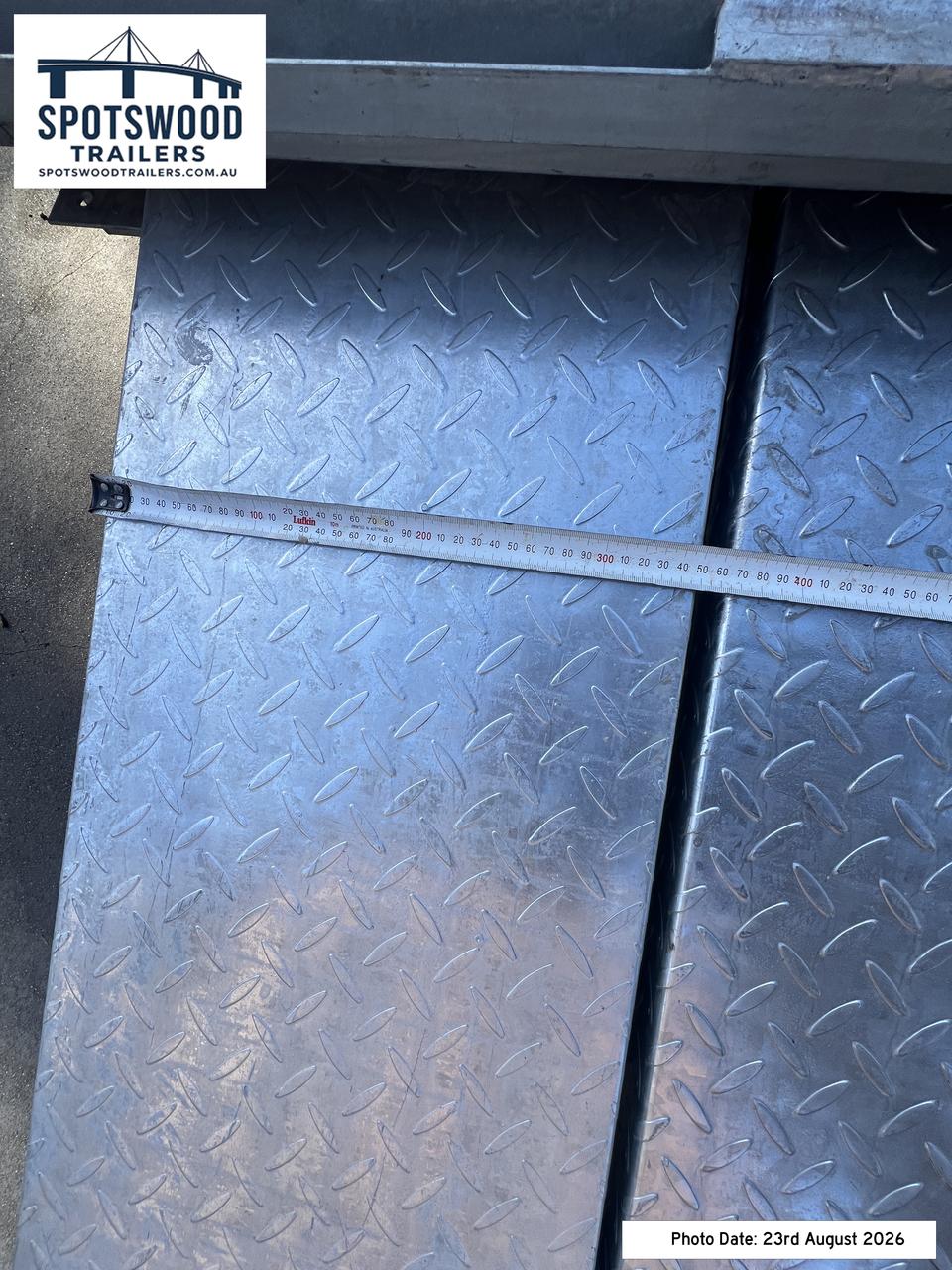 Width measurement of a checkerplate loading ramp supplied with The Deckhand trailer