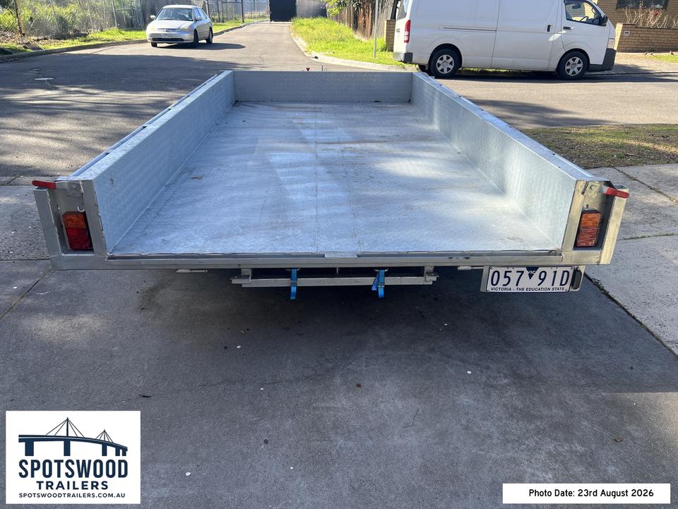 Rear view showing under-deck loading ramp storage on The Deckhand 12x6 trailer